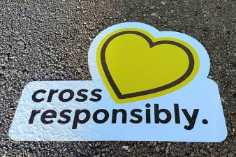 sidewalk decal saying cross responsibly